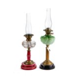 A LATE VICTORIAN TABLE OIL LAMP with floral moulded green glass fount on a reeded brass column and