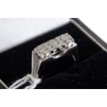 AN 18CT WHITE GOLD RING set with twelve diamonds, stamped 750, size P, approximately 5.9 grams.