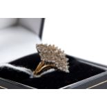 A 14K YELLOW GOLD DIAMOND CLUSTER RING, size N, approximately 3.8 grams.