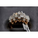 A 10K YELLOW GOLD DIAMOND CLUSTER RING, size N, stamped 10k, approximately 4.6 grams.