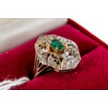 A 9CT YELLOW GOLD EMERALD AND DIAMOND FOLIATE PIERCED RING, size N, approximately 3.6 grams.