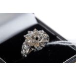 A 9CT WHITE GOLD DIAMOND FLOWER HEAD RING, size Q, approximately 4.6 grams.