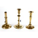 AN 18TH CENTURY BRASS CANDLESTICK with tapered stem and octagonal base, 7 1/2 ins high and an 18th