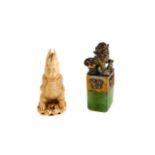 AN EARLY 20TH CENTURY CHINESE GREEN HARDSTONE SEAL surmounted by a cast metal kylin dog, 2 1/2 ins