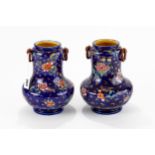 A PAIR OF LATE 19TH CENTURY WEDGWOOD POTTERY AESTHETIC STYLE VASES blue ground with ring handles and