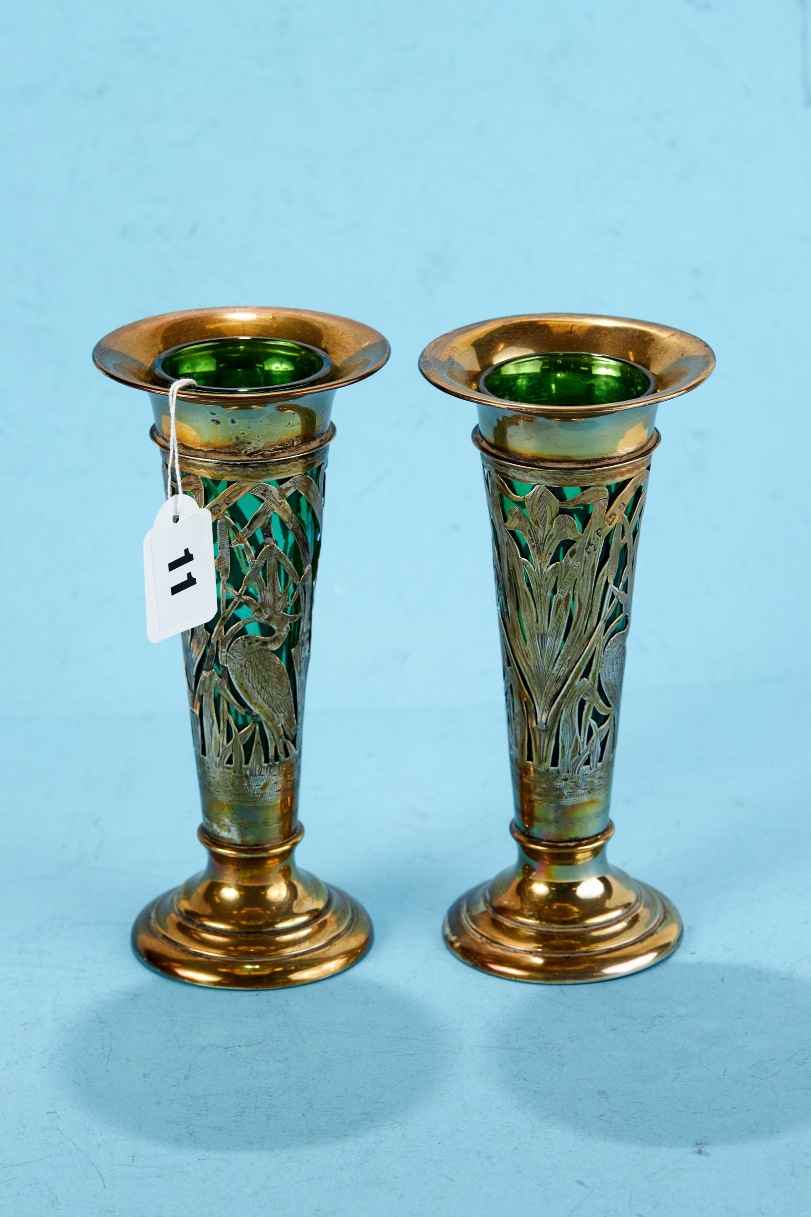 A PAIR OF EDWARDIAN PIERCED SILVER TRUMPET SHAPED VASES decorated with birds amongst flowers and