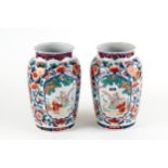 A PAIR OF LATE 19TH/EARLY 20TH CENTURY JAPANESE IMARI PORCELAIN VASES decorated with panels of