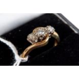 A 9CT YELLOW GOLD ILLUSION SET THREE STONE DIAMOND RING, 25 carats, size O, approximately 4.7 grams.