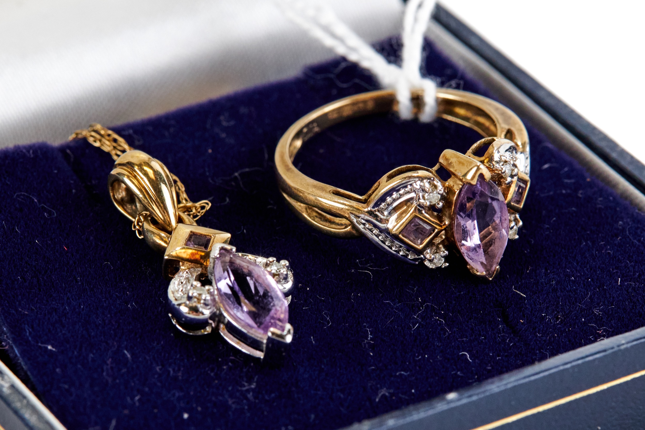 A LADY'S YELLOW METAL AMETHYST AND DIAMOND RING, size P and a matching amethyst and diamond PENDANT,