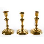 AN 18TH CENTURY BRASS CANDLESTICK with inverted baluster stem on a canted corner base, 7 ins high
