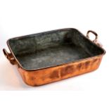 A LARGE RECTANGULAR GEORGIAN COPPER COOKING PAN with hinged brass handles, 21 ins x 17 ins.