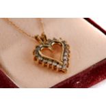 A 10K YELLOW GOLD HEART SHAPED PENDANT set with twenty diamonds on a 10k fine link NECKCHAIN,