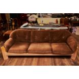 A 1970/80'S DESIGNER THREE PIECE SUITE, oak frame with detachable brown velour seat-cum-arm