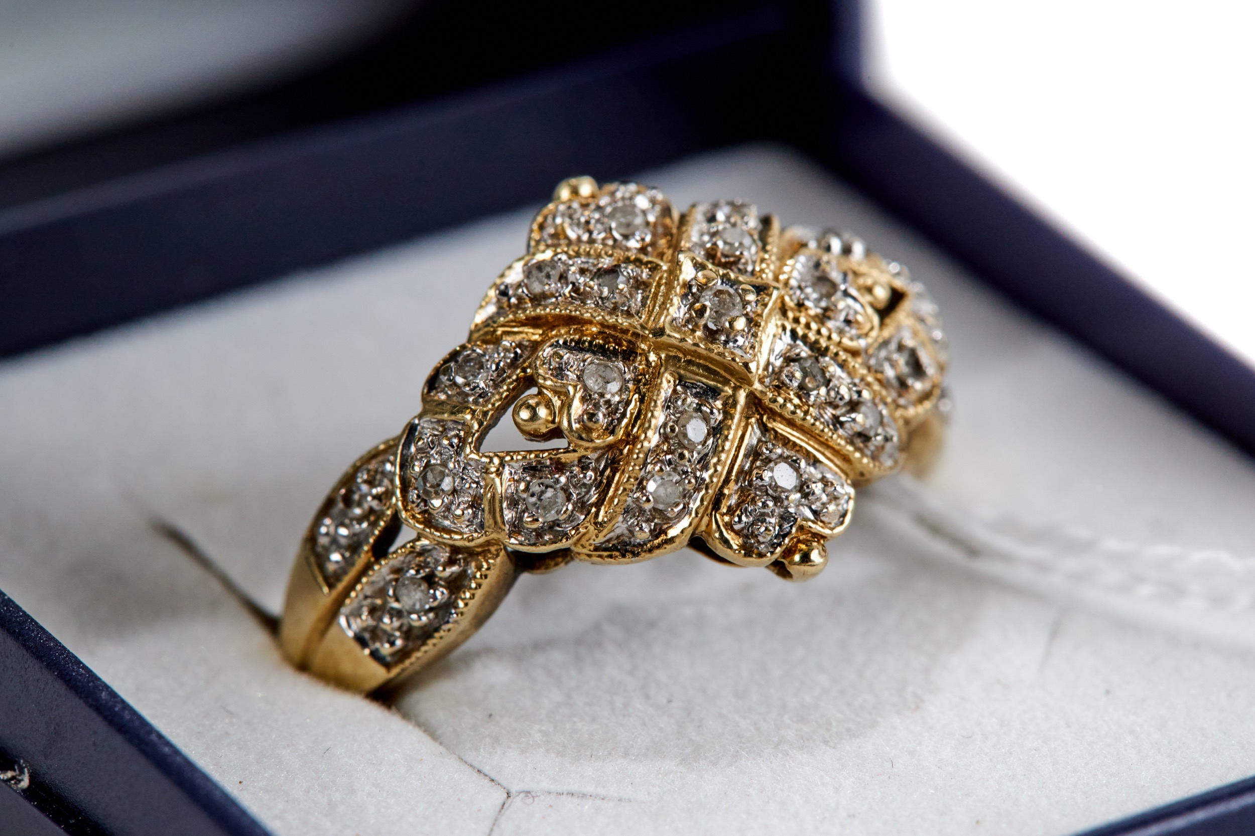 A 9CT GOLD MULTI DIAMOND SET RING with diamond shoulders, size Q, approximately 3.9 grams.