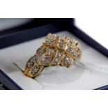 A 9CT GOLD MULTI DIAMOND SET RING with diamond shoulders, size Q, approximately 3.9 grams.