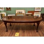 A 1920/30'S MAHOGANY EXTENDING DINING TABLE, rounded ends with two extra leaves raised on cabriole