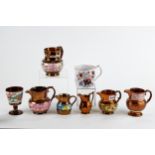 SIX VICTORIAN COPPER LUSTRE JUGS and a 19th Century porcelain Imari pattern MUG, 4 ins high. (7)