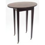 A 19thC mahogany oval occasional table. Approx. 27" tall Please Note - we do not make reference to