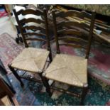 A pair of 20thC rush seated ladder back dining chairs. Each approx. 37" tall (2) Please Note - we do