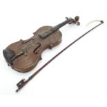 A late 19thC Continental violin with bow Please Note - we do not make reference to the condition