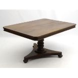 A mid 19thC mahogany tilt top breakfast table, with large rectangular top above a turned column