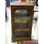 A glazed bookcase and books. Approx. 41" tall Please Note - we do not make reference to the