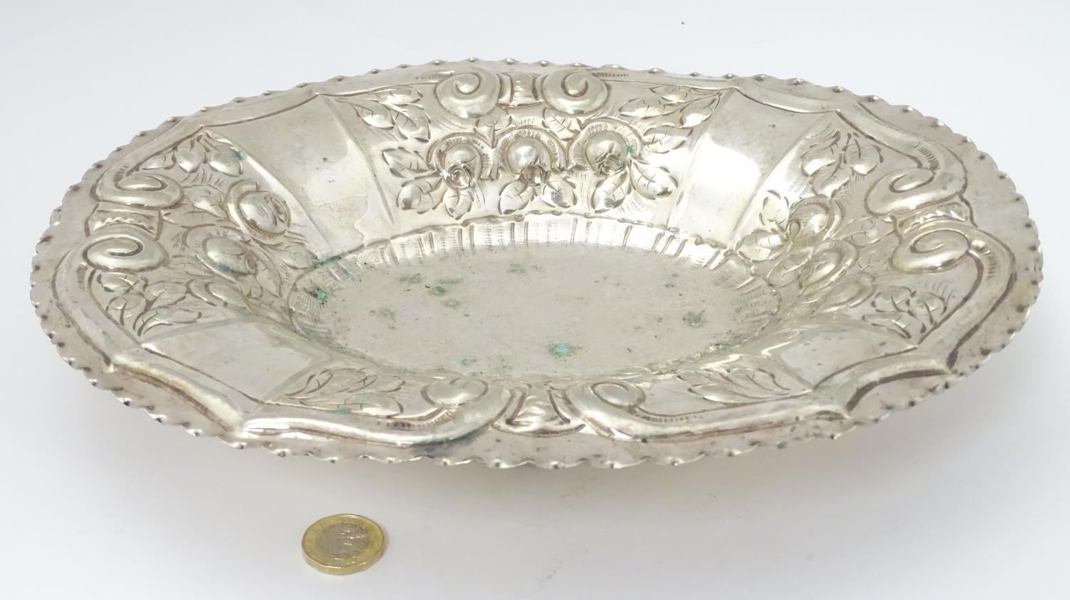 A silver plate dish of oval form with embossed decoration. Approx. 12" wide. Please Note - we do not - Image 4 of 5