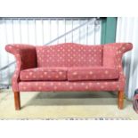 A humpback upholstered two seater sofa with fleur de lys decoration Please Note - we do not make