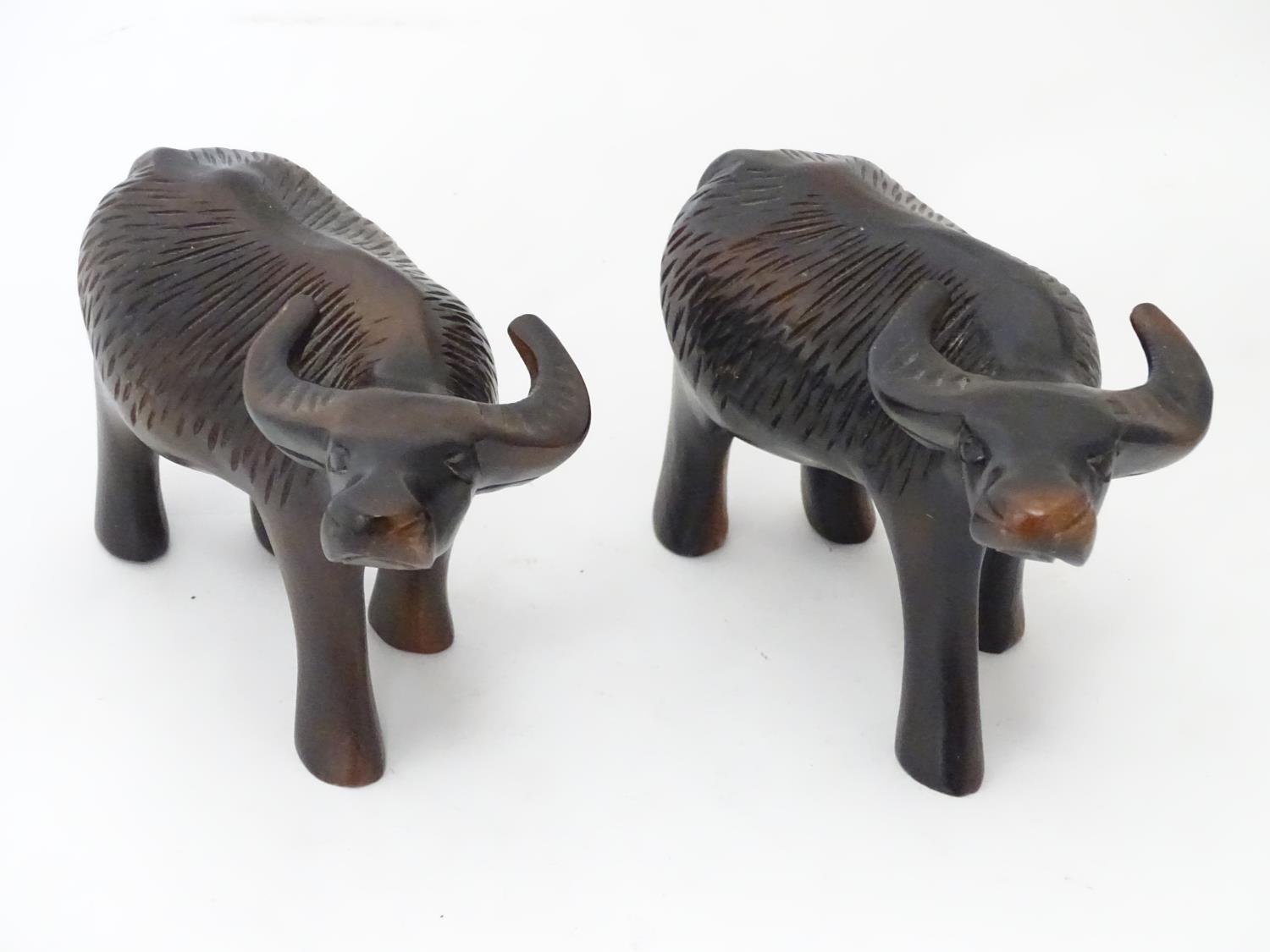 A pair of carved wooden buffalo / ox Please Note - we do not make reference to the condition of lots