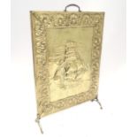 A brass fire guard with ship decoration. Approx. 26 1/2" tall Please Note - we do not make reference