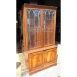 A 20thC glazed mahogany bookcase. Approx. 75" tall Please Note - we do not make reference to the