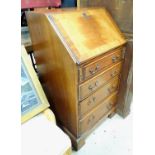 A 20thC small mahogany bureau. Approx. 38" tall Please Note - we do not make reference to the