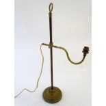 Lighting: an early-20thC brass table lamp, the arm adjustable for height and angle, standing on a