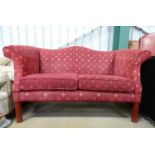 A 20thC upholstered two seated sofa with fleur de lys decoration Please Note - we do not make