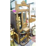 An early 20thC oak hall stand with 6 hooks, central mirror, glove box and stick stand. Approx. 31"