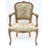 A 20thC fauteuil style walnut chair with tapestry upholstery Please Note - we do not make