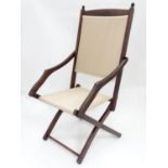 A folding campaign / deck chair. Approx. 41" tall Please Note - we do not make