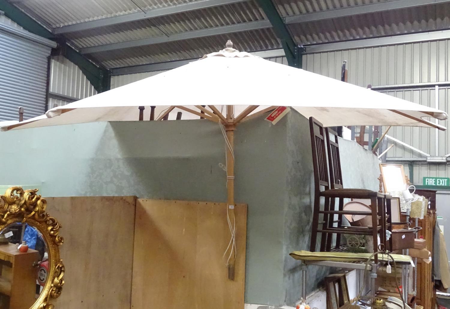 A large parasol. Approx. 7ft wide Please Note - we do not make reference to the condition of lots