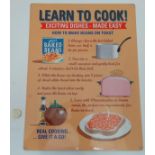 A 21stC metal sign, 15 3/4'' x 11 3/4'' wide, 'Learn to Cook' 'Exciting dishes-Made easy' Please