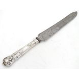 A white metal handled knife Please Note - we do not make reference to the condition of lots within