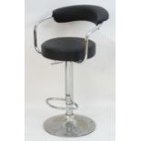 A late 20thC adjustable swivel seat with an upholstered curved backrest and rounded seat, having a