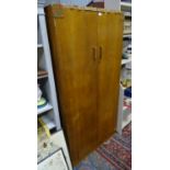 A 2 door light oak wardrobe by E. Gomme. Approx. 70" tall Please Note - we do not make reference