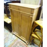 A stripped pine housekeeper's cupboard with two doors, three shelves and a drawer above. Approx. 56"