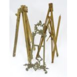 Two small wooden artist's easels, together with a brass easel (3) Please Note - we do not make