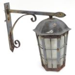 An exterior lantern on a bracket Please Note - we do not make reference to the condition of lots