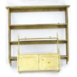 A pine wall hanging plate rack, together with a wall hanging spice cupboard / rack. The largest 36