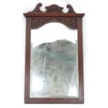 A mirror with a carved mahogany surround. Approx. 34 1/2" tall Please Note - we do not make