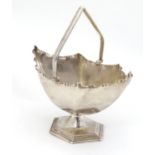 A silver plate sugar basket 6 1/4" long Please Note - we do not make reference to the condition of