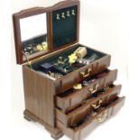 A jewellery box containing a quantity of assorted jewellery to include brooches, earrings, rings,