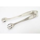 Silver sugar tongs with claw formed grips and punch bead border. Hallmarked Birmingham 1923 maker